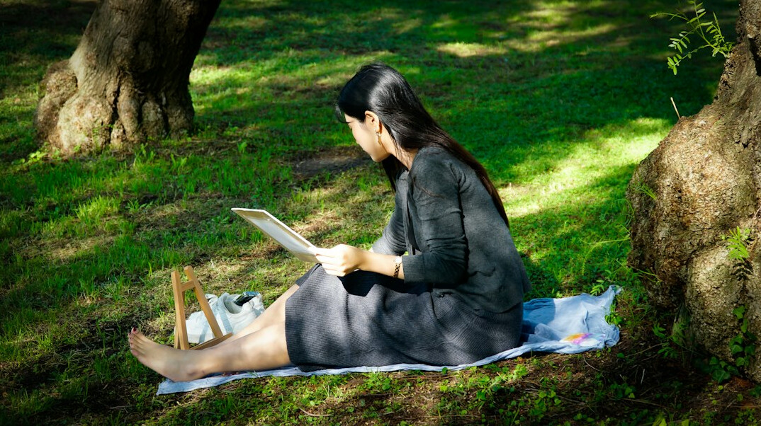 Smiling woman reflecting at her desk